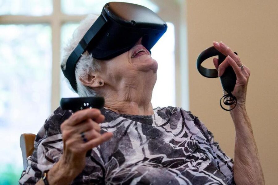 This photo shows Joy Kay, resident at The Fountains at La Cholla, using a virtual reality device to ride a roller coaster similar to the one she grew up with during the virtual reality program, ″EngageVR″. 